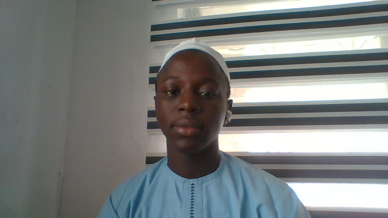 Badmus Abdul Basit coding on his laptop